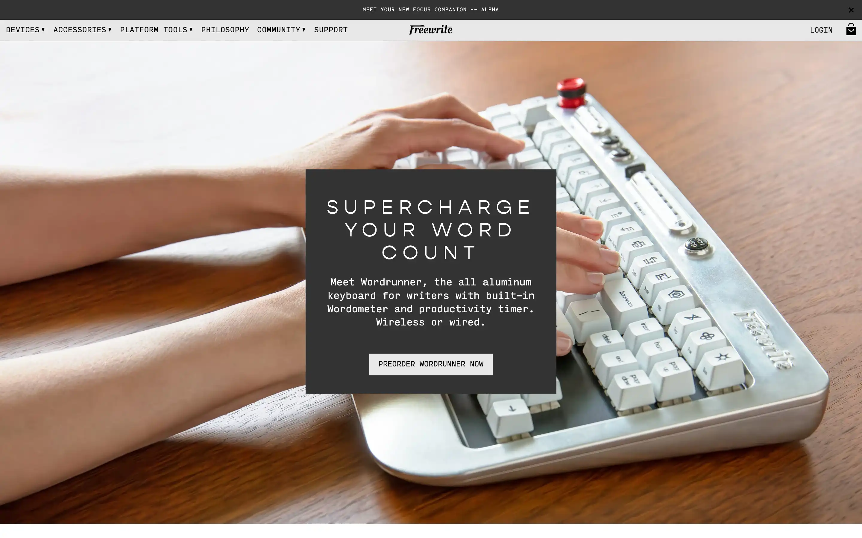 Hands typing on aluminum keyboard with productivity tools.