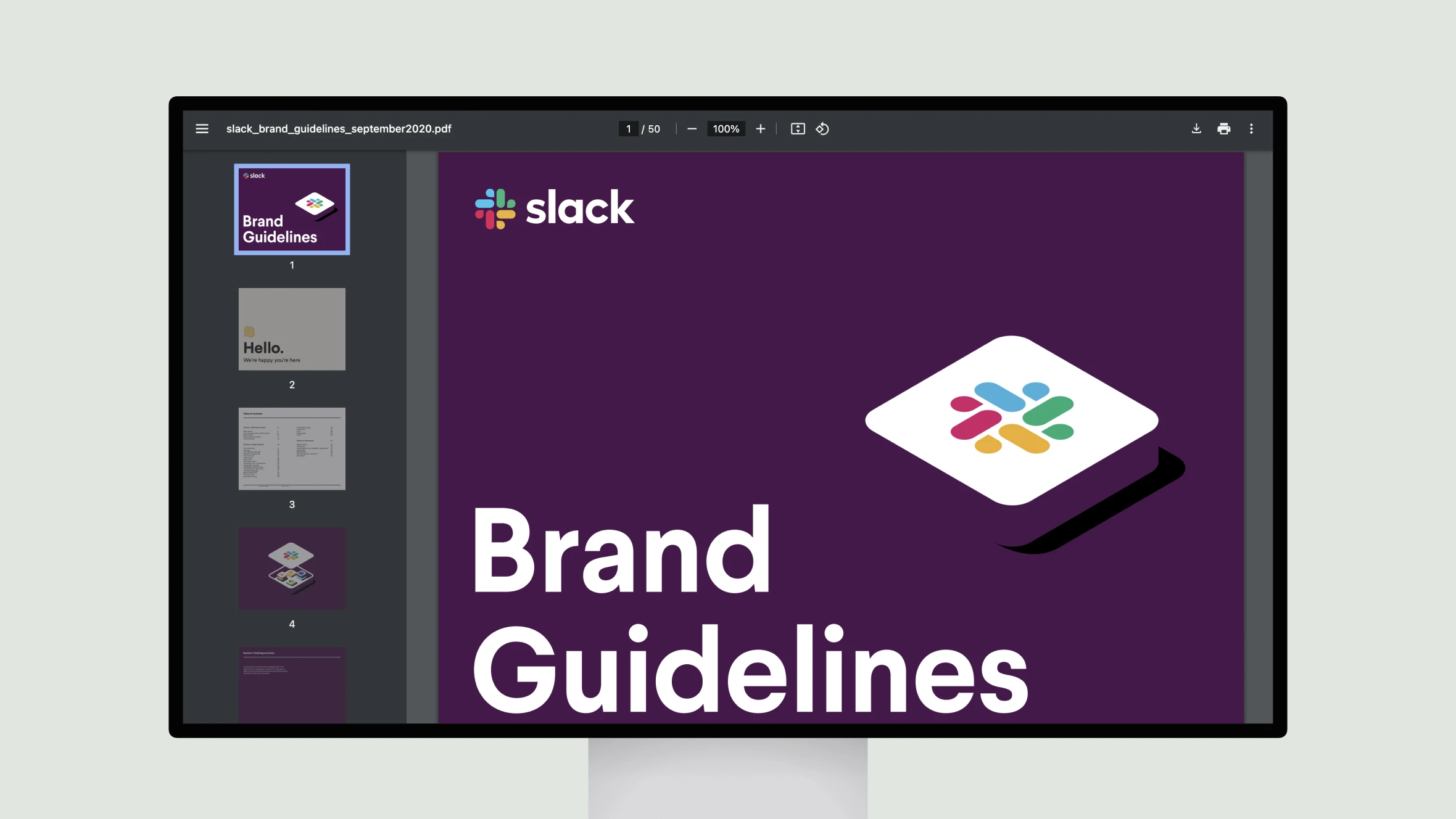 Monitor displaying Slack brand guidelines PDF.