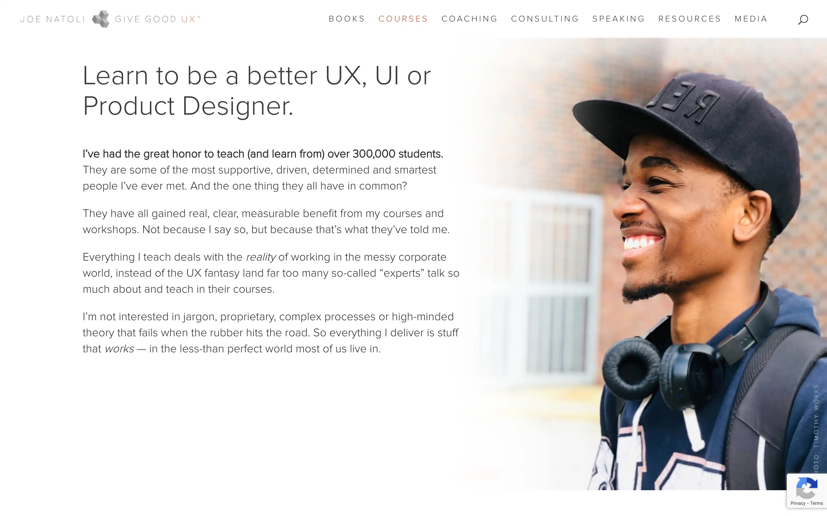Smiling person with headphones and cap
