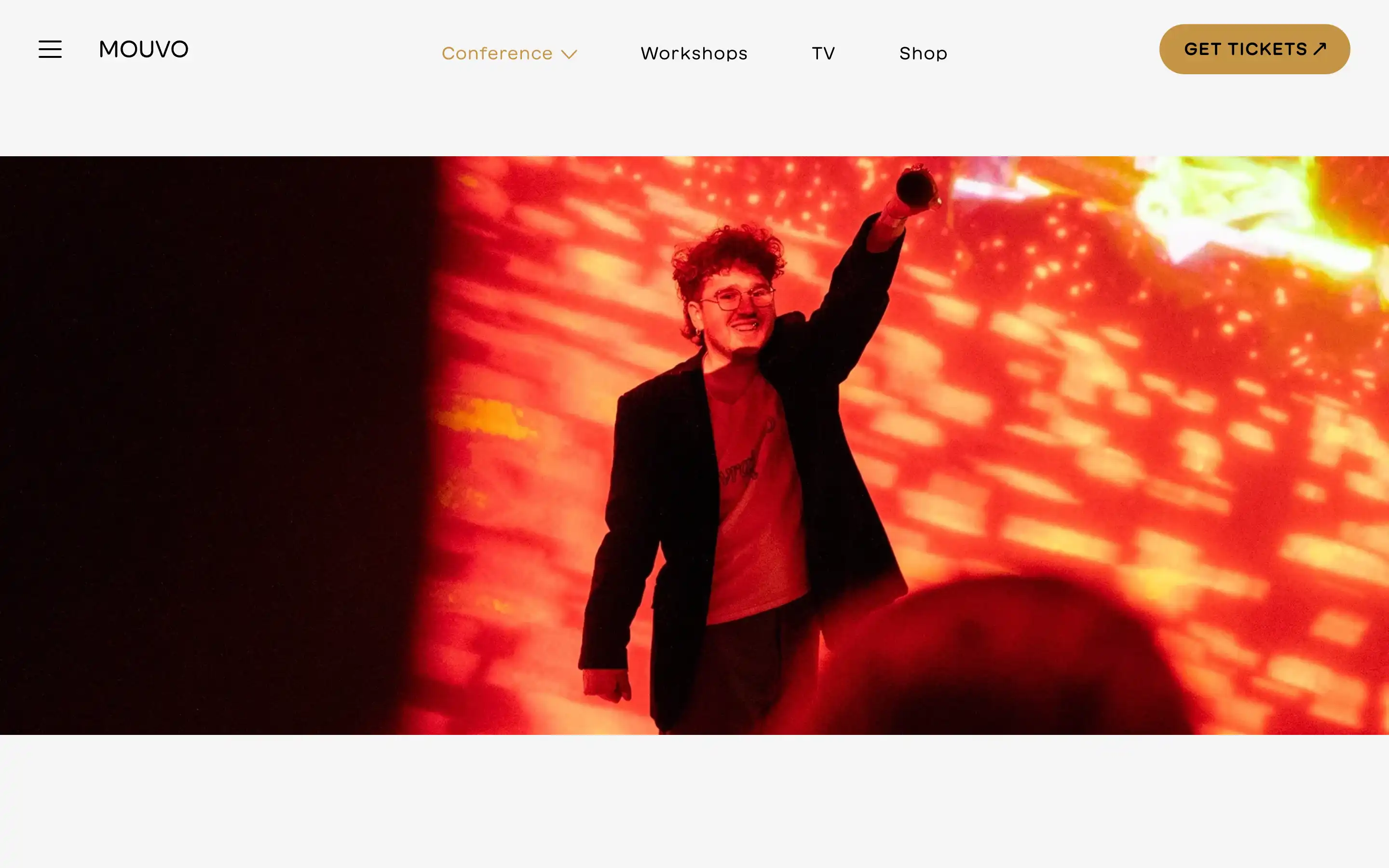 Person on stage with dynamic red background.